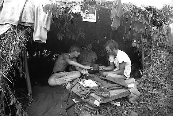 17, 1969, photo at the Woodstock Music and Art Festival in Bethel, N.Y., music fans take shelter in a grass hut at the festival.
