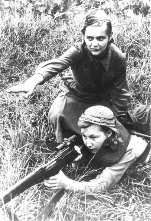 Female Soviet Sniper training a Partisan Fighter on the Eastern Front. WW2.